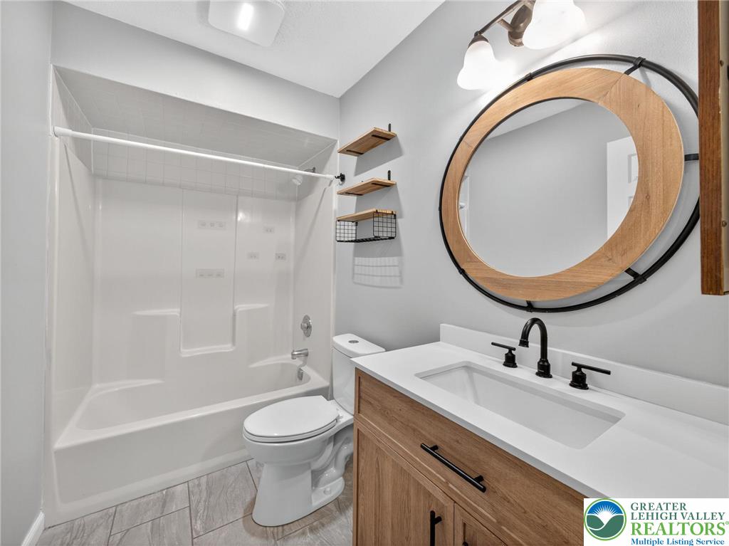 2149 Allen Street Allentown, PA 18104 - Photo 21 of 24 a bathroom with a sink a toilet and a mirror