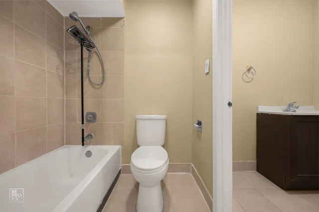 a bathroom with a toilet sink and shower