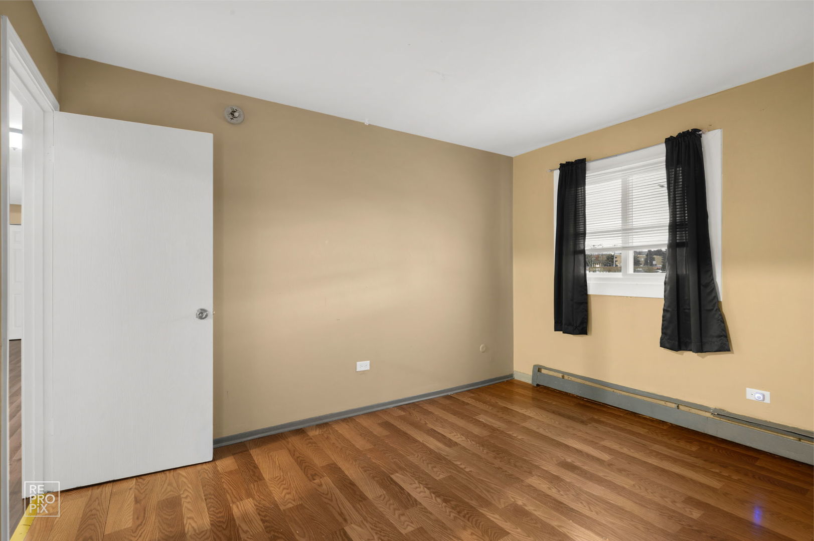 107 West Elk Trail, Unit 106 Carol Stream, IL 60188 - Photo 13 of 15 a view of an empty room with wooden floor and a window