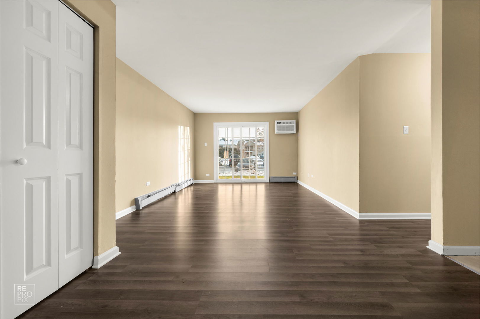 107 West Elk Trail, Unit 106 Carol Stream, IL 60188 - Photo 2 of 15 a view of an empty room with wooden floor and a window