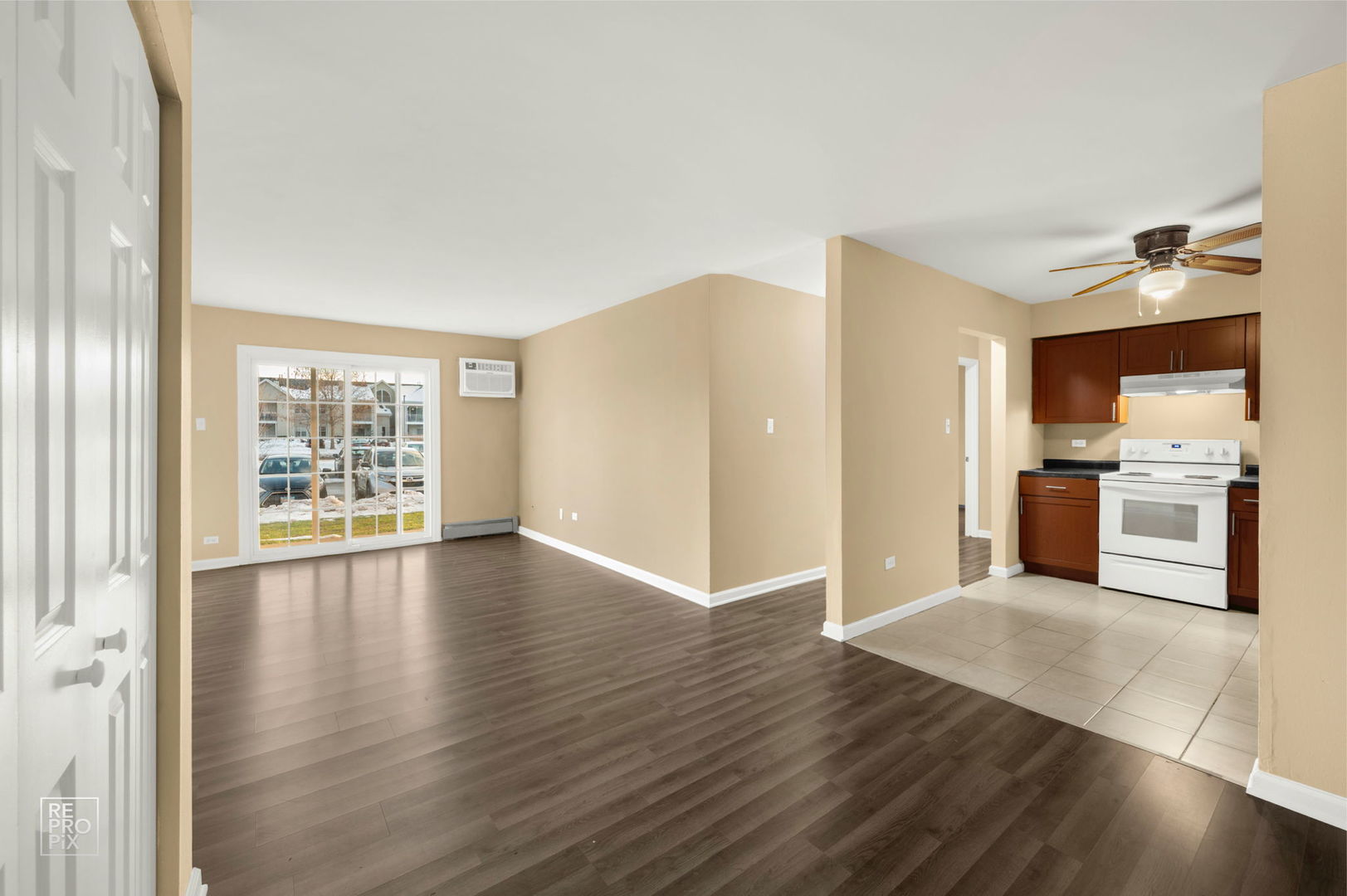 107 West Elk Trail, Unit 106 Carol Stream, IL 60188 - Photo 3 of 15 a view of a kitchen with wooden floor and a refrigerator