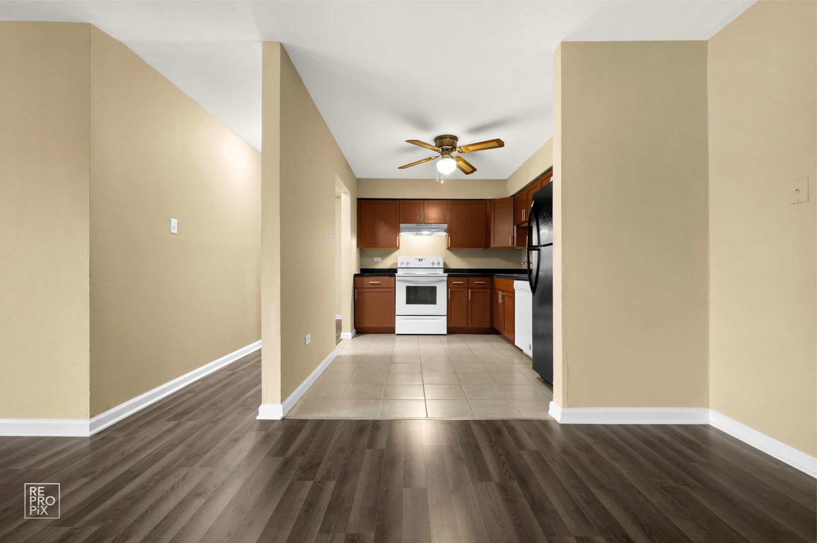 107 West Elk Trail, Unit 106 Carol Stream, IL 60188 - Photo 5 of 15 a view of a kitchen with wooden floor and a ceiling fan