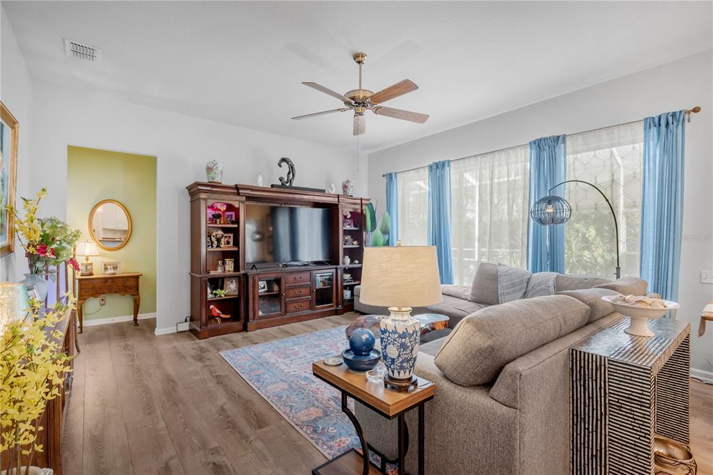 19015 Fern Meadow Loop Lutz, FL 33558 - Photo 6 of 50 a living room with furniture a ceiling fan and a window