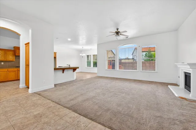 an empty room with windows and fireplace