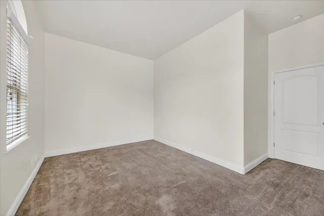 an empty room with windows mirror and windows