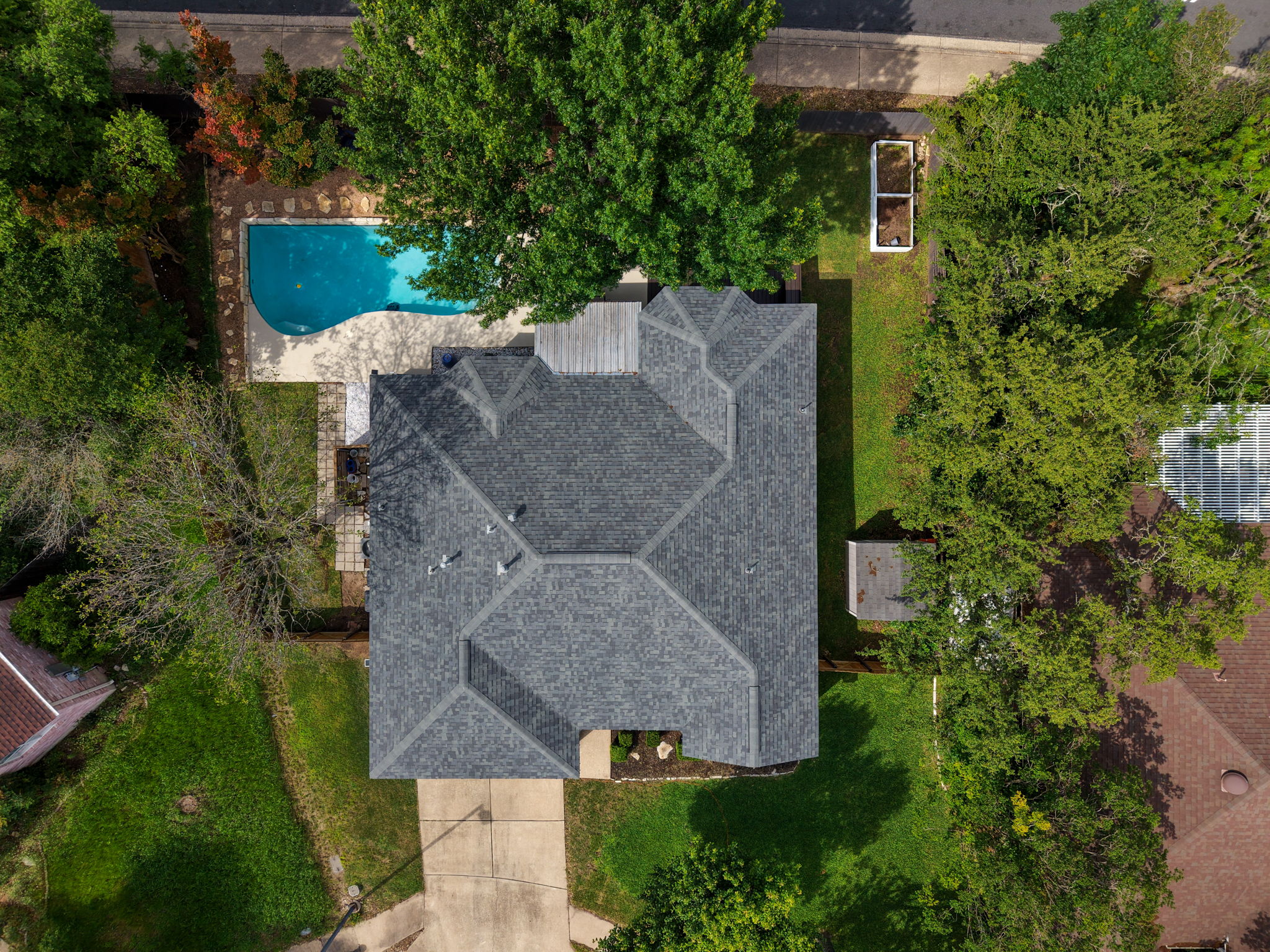 9024 Heiden Lane Austin, TX 78749 - Photo 28 of 28 Aerial perspective highlighting a residential property featuring a dark gray shingle roof and a concrete driveway