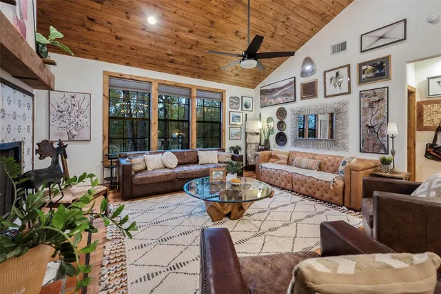a living room with furniture large window and a fireplace