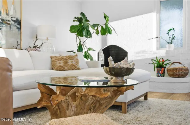 a living room with furniture flowerpot and a potted plant