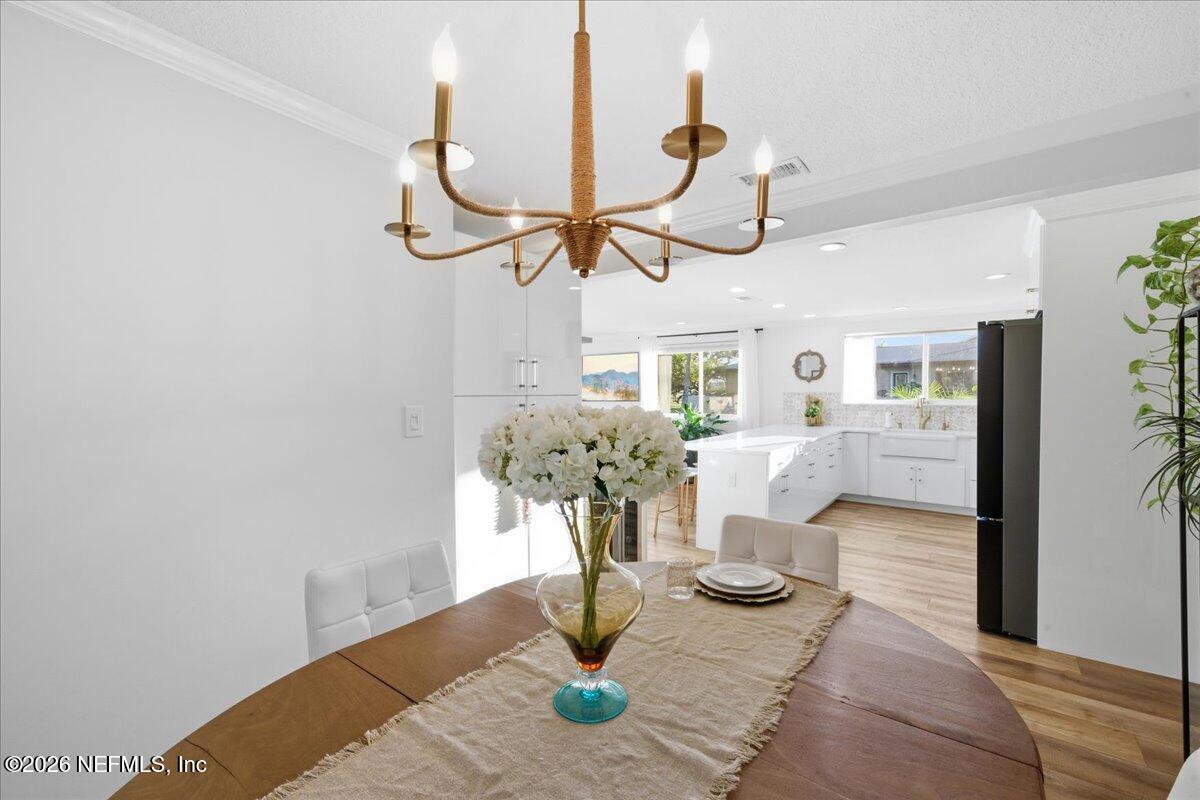 149 Menendez Road St. Augustine, FL 32080 - Photo 23 of 55 Dining Room With Statement Chandelier