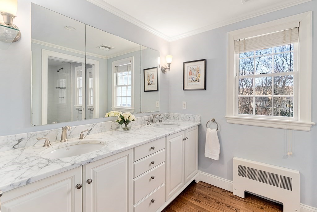 7 Nantucket Road Wellesley, MA 02481 - Photo 24 of 37 a bathroom with a granite countertop double vanity sink a large mirror a vanity and next to a window