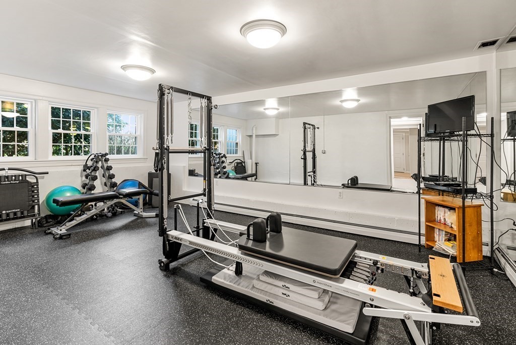 7 Nantucket Road Wellesley, MA 02481 - Photo 32 of 37 a living room with gym equipment and a flat screen tv