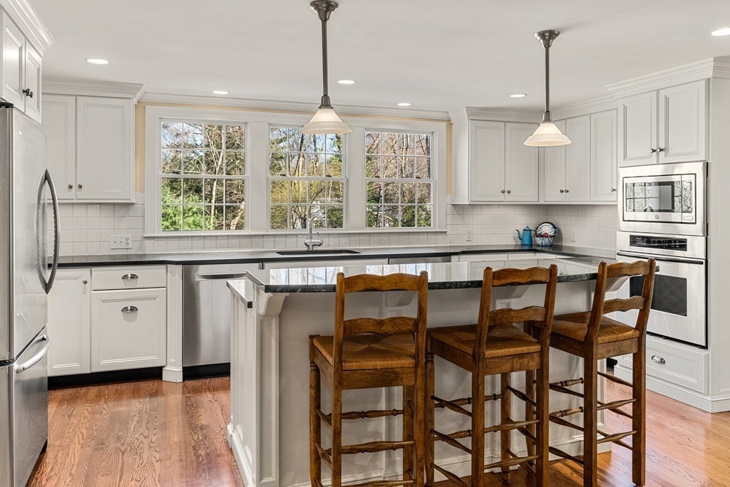7 Nantucket Road Wellesley, MA 02481 - Photo 6 of 37 a kitchen with stainless steel appliances granite countertop a stove top oven a refrigerator and cabinets
