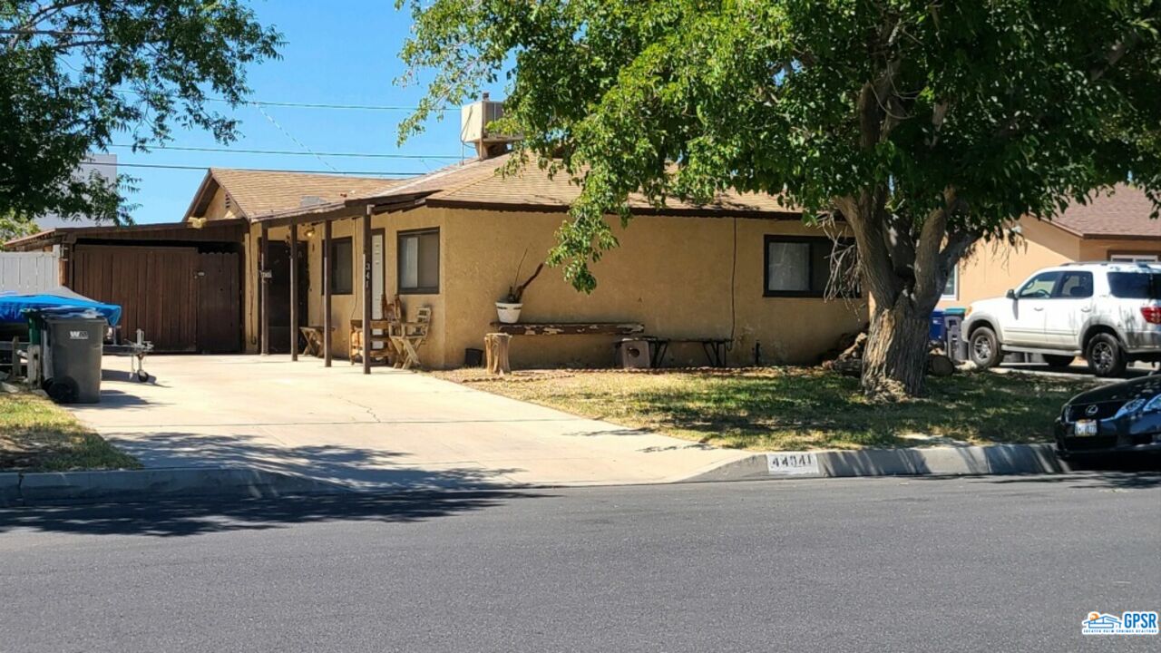 44341 Glenraven Road Lancaster, CA 93535 - Photo 1 of 1 a front view of a house with a yard and garage