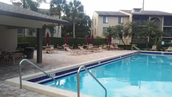 a swimming pool with outdoor seating and yard