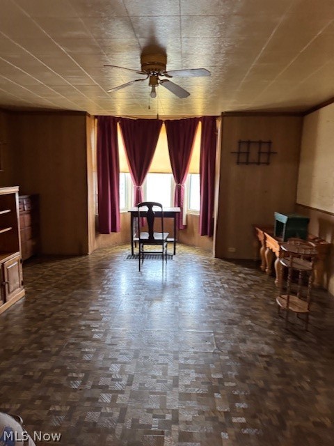 626 High Street Wellsburg, WV 26070 - Photo 17 of 18 Dining area with ceiling fan, dark floors, and wooden walls