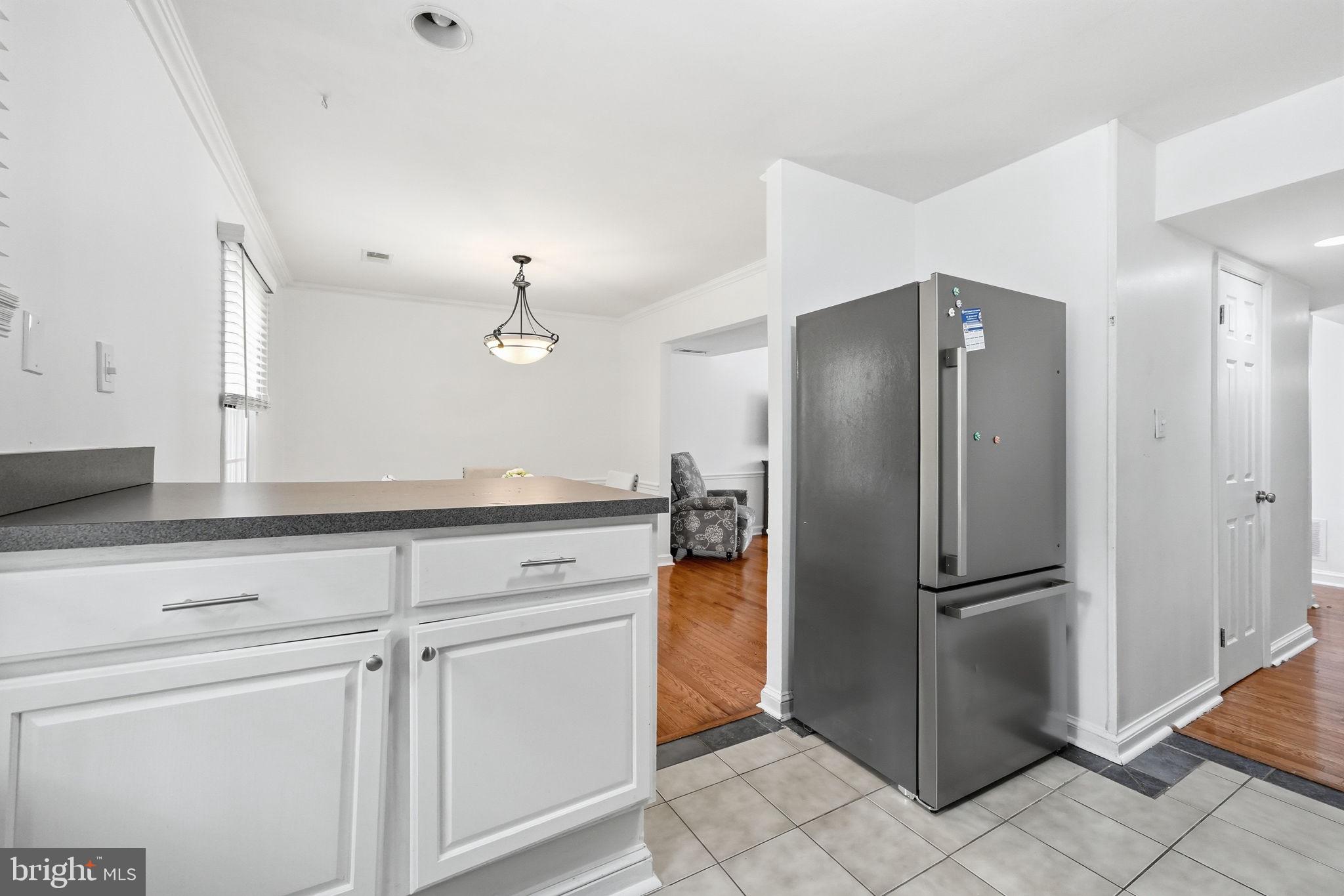 8260 Getty Court Springfield, VA 22153 - Photo 13 of 31 a kitchen with a refrigerator and cabinets