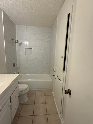 a bathroom with a toilet and a bathtub