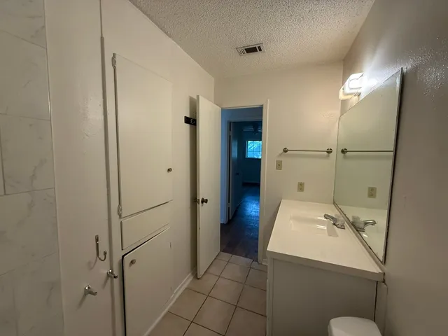 a view of backyard with wooden fence and large trees