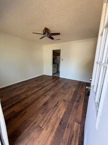 a view of a room with wooden floor