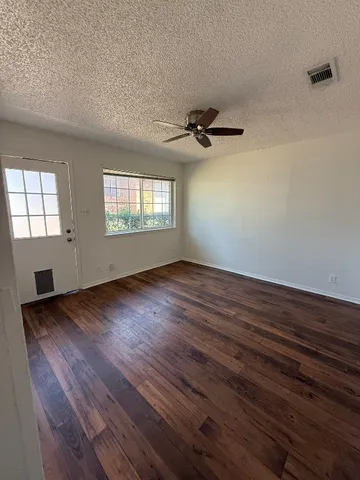 wooden floor in an empty room with a window
