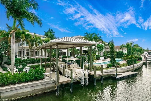 a view of house with swimming pool and outdoor seating
