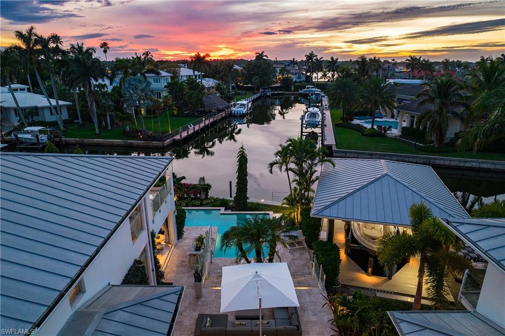 2290 Tarpon Road Naples, FL 34102 - Photo 15 of 50 a view of a balcony with two chairs and a table