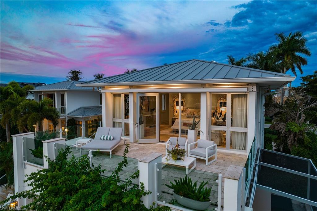 2290 Tarpon Road Naples, FL 34102 - Photo 16 of 50 a view of a house with backyard sitting area and garden
