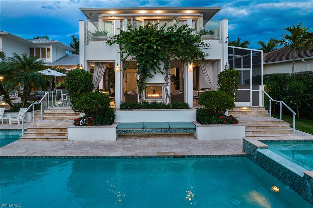 2290 Tarpon Road Naples, FL 34102 - Photo 18 of 50 a front view of a house with garden