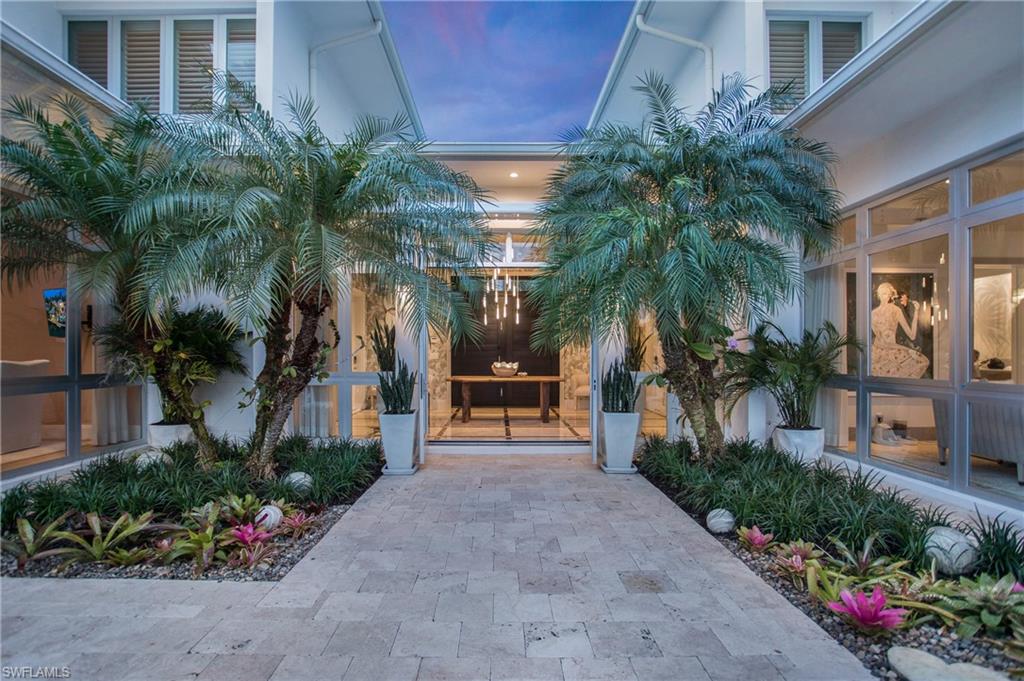 2290 Tarpon Road Naples, FL 34102 - Photo 19 of 50 a front view of house with yard and green space