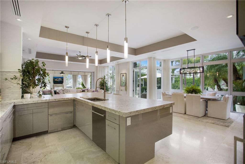2290 Tarpon Road Naples, FL 34102 - Photo 22 of 50 a large white kitchen with a large window and sink