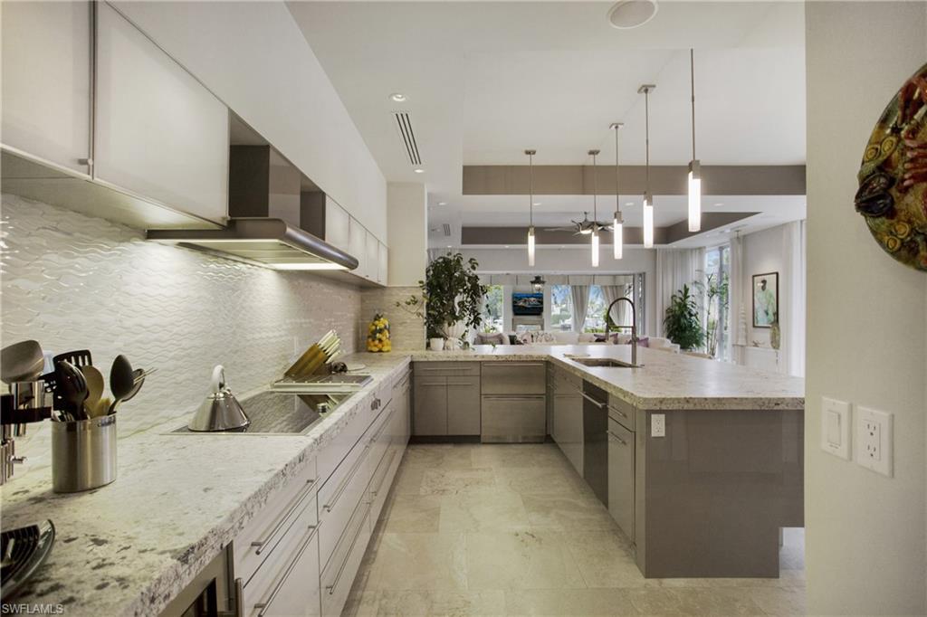 2290 Tarpon Road Naples, FL 34102 - Photo 24 of 50 a kitchen with stainless steel appliances granite countertop a sink a stove and a refrigerator