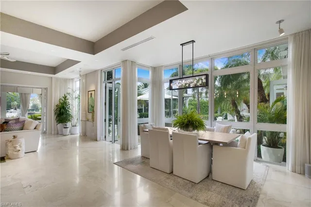 a living room with furniture and large windows