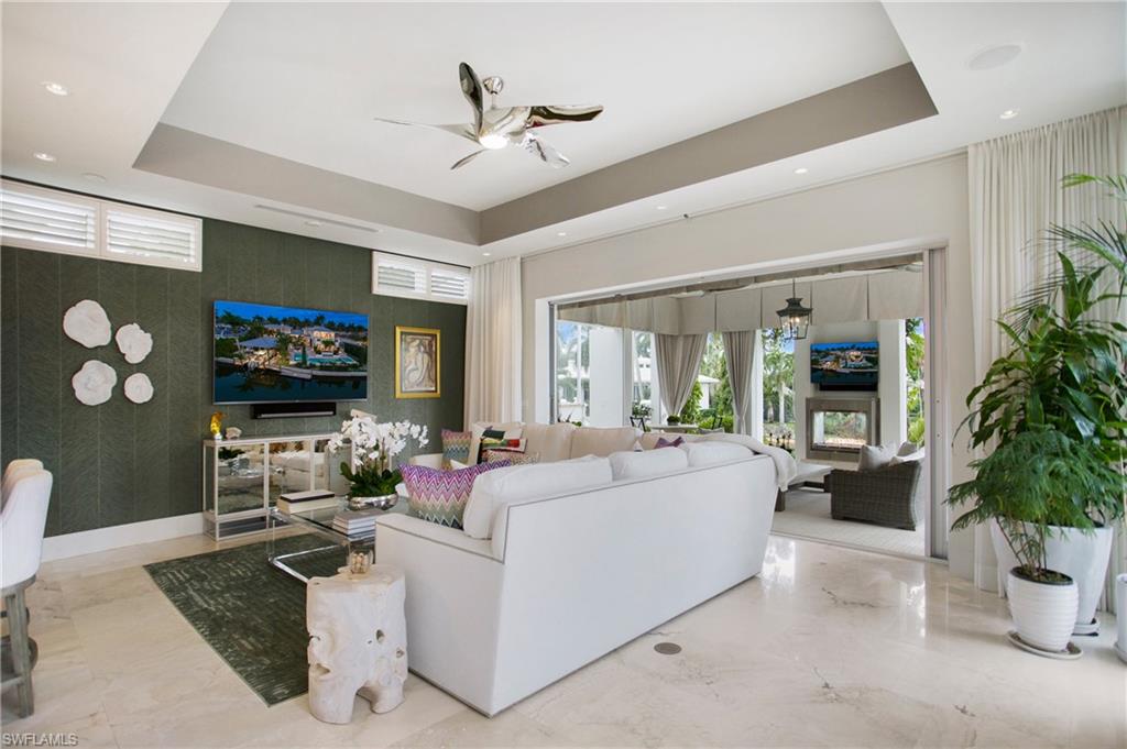2290 Tarpon Road Naples, FL 34102 - Photo 28 of 50 a living room with furniture and a flat screen tv