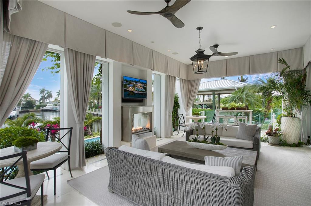 2290 Tarpon Road Naples, FL 34102 - Photo 30 of 50 a living room with furniture and a large window