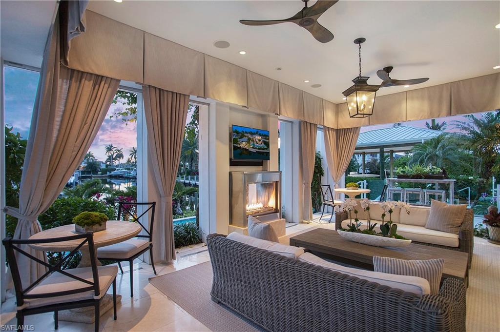 2290 Tarpon Road Naples, FL 34102 - Photo 32 of 50 a living room with furniture and a large window