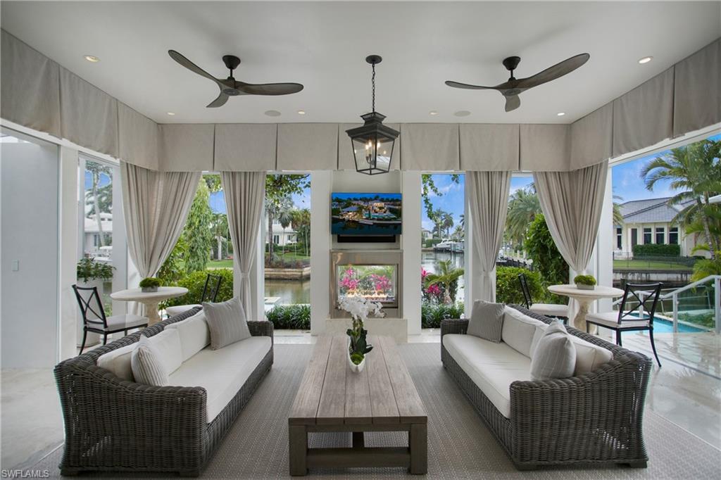 2290 Tarpon Road Naples, FL 34102 - Photo 33 of 50 a living room with furniture ceiling fan and a window