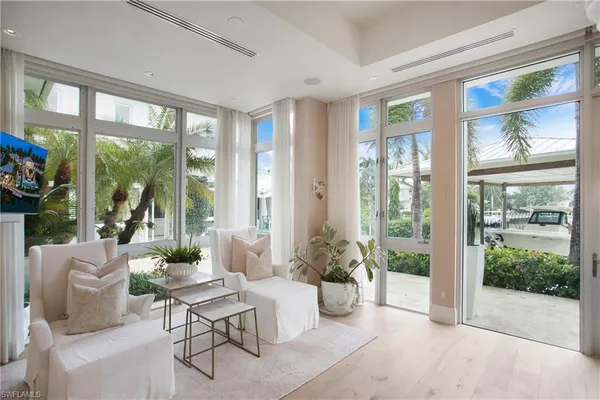 a living room with furniture and a potted plant
