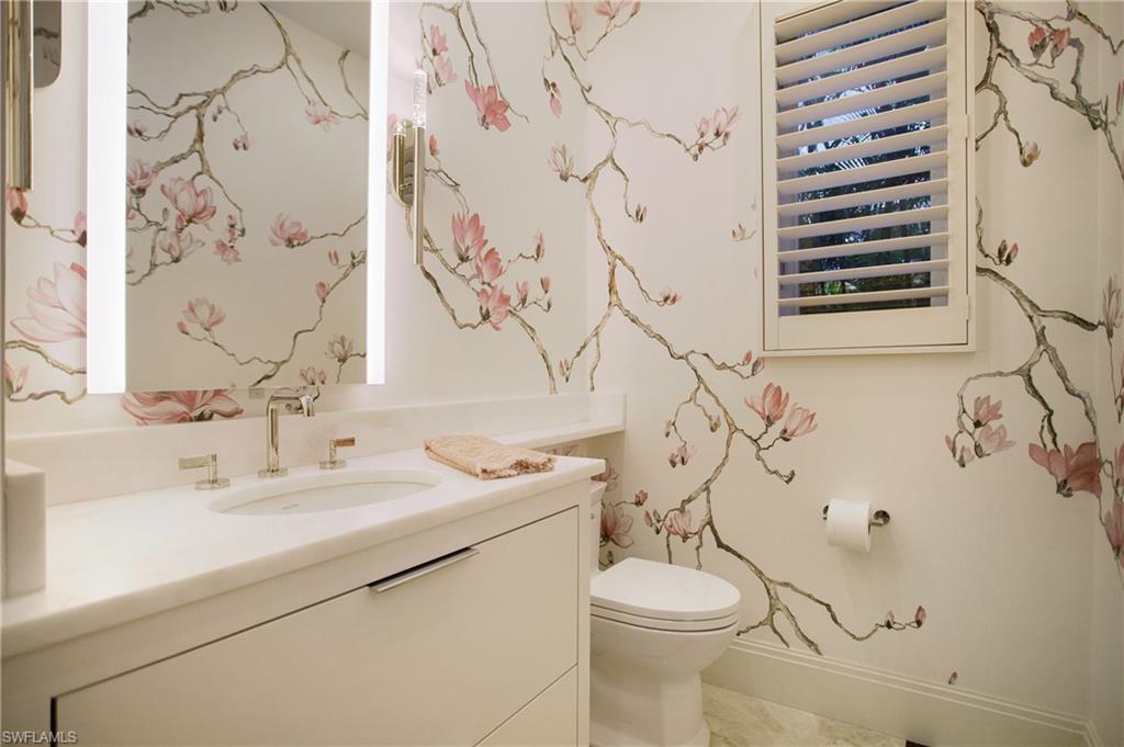 2290 Tarpon Road Naples, FL 34102 - Photo 37 of 50 a bathroom with a sink and mirror with toilet