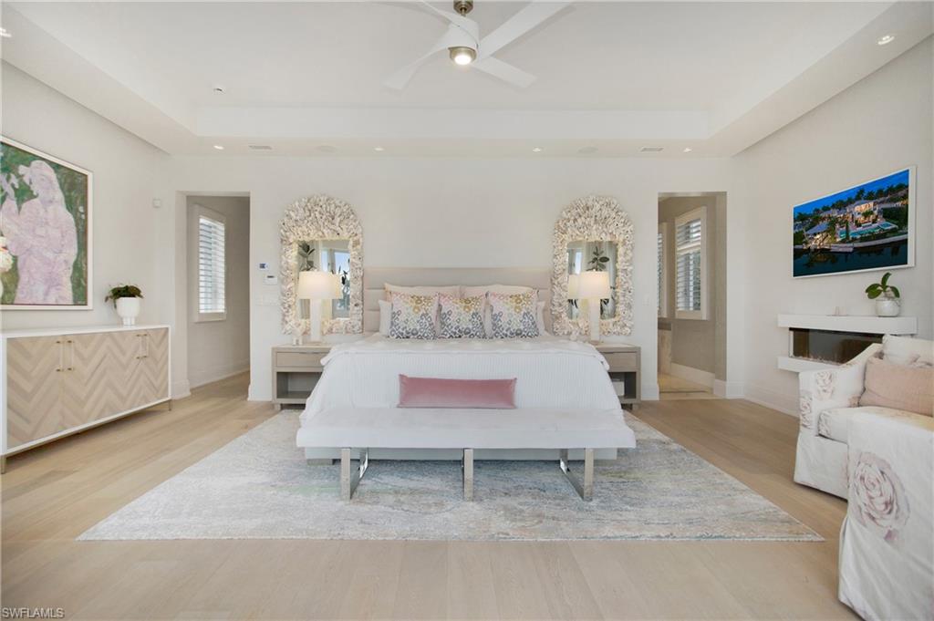 2290 Tarpon Road Naples, FL 34102 - Photo 40 of 50 a living room with furniture a flat screen tv and a fireplace