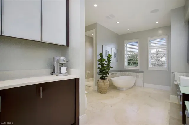 a view of a dining room with furniture a rug and a large window