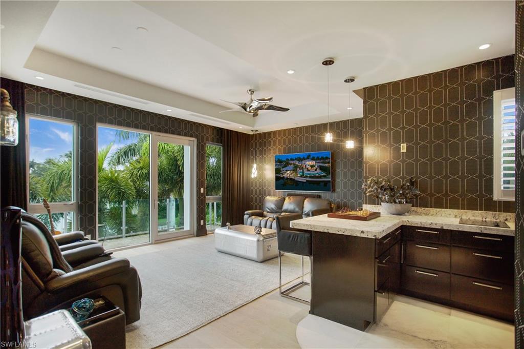 2290 Tarpon Road Naples, FL 34102 - Photo 44 of 50 a view of a dining room with furniture a rug and a large window