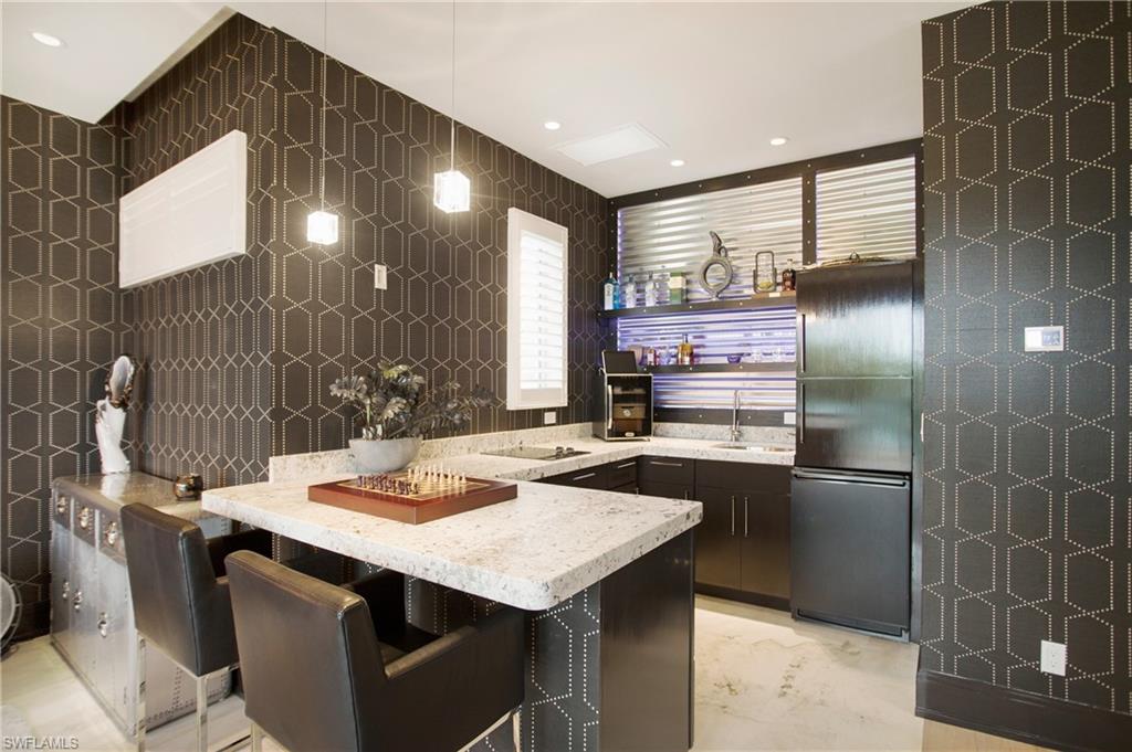 2290 Tarpon Road Naples, FL 34102 - Photo 45 of 50 a kitchen with stainless steel appliances kitchen island granite countertop a sink and cabinets