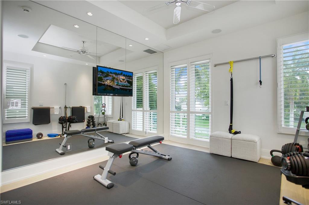 2290 Tarpon Road Naples, FL 34102 - Photo 46 of 50 a living room with furniture large window and flat screen tv