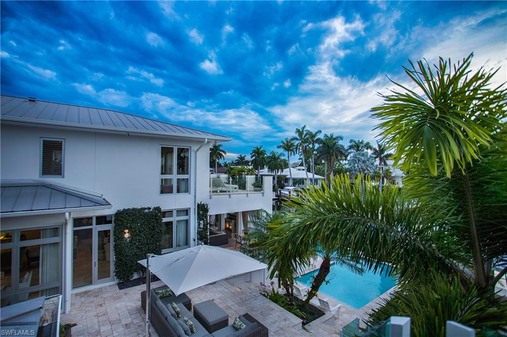 2290 Tarpon Road Naples, FL 34102 - Photo 7 of 50 a view of a backyard with plants and a patio