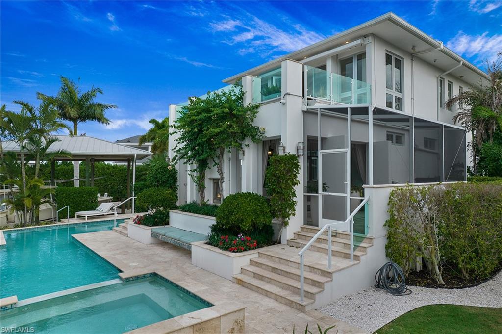 2290 Tarpon Road Naples, FL 34102 - Photo 10 of 50 a front view of a house with garden