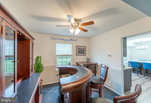 a dining room with furniture window and wooden floor