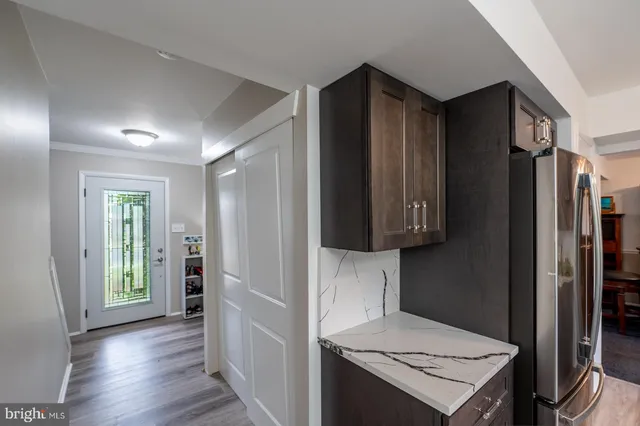 a view of a dining room with furniture a chandelier and wooden floor