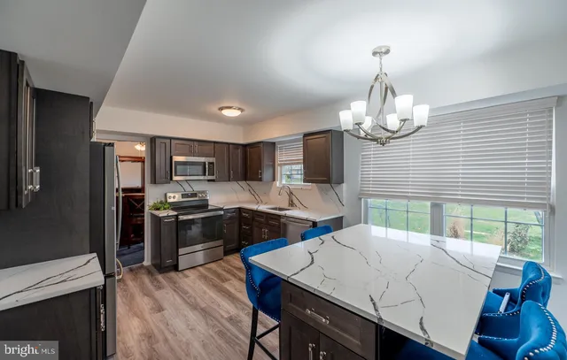 a kitchen with granite countertop a sink and a stove top oven