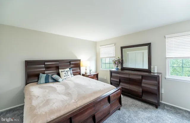 a bathroom with a sink vanity and a window