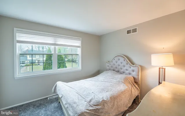 a bathroom with a painting on the wall and a shower